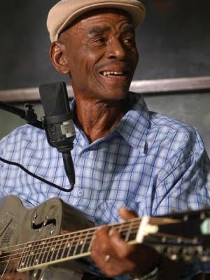 John Dee Holeman (1929-2021) was an innovative traditional bearer of the Piedmont Blues style. He lived, worked and performed in and around Orange and Durham Counties.